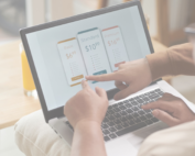 Person on laptop showing subscription prices on the screen